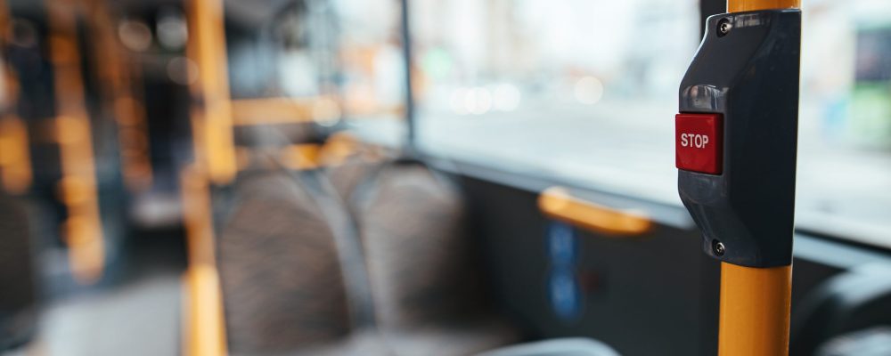 Close-up of handle in empty public bus during COVID-19 pandemic.